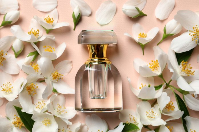 fragrance bottle surrounded by jasmine