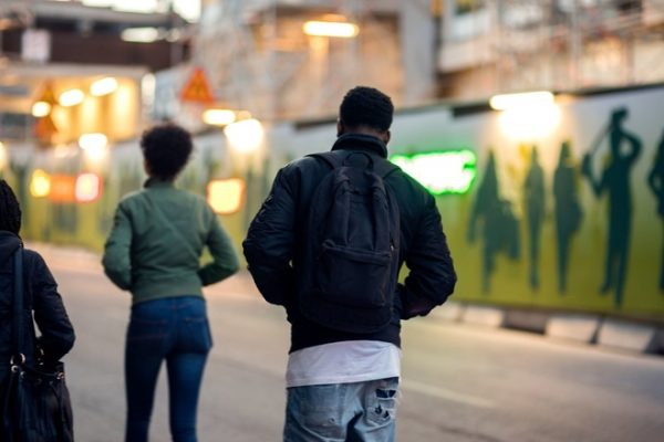 young black man and woman walking