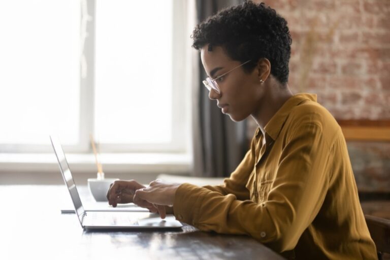 Black woman at computer using AI.