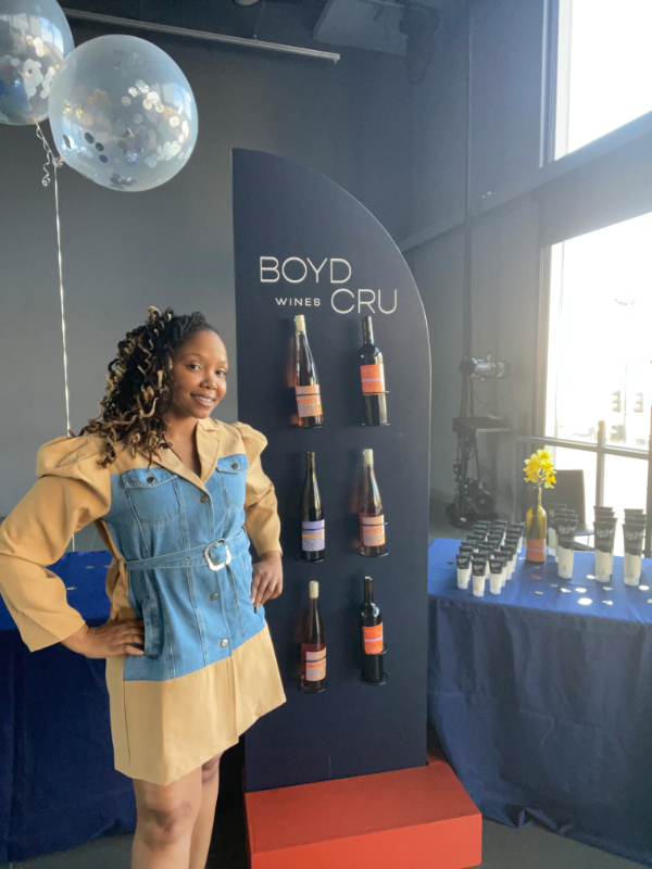 Fancy standing in front of Boyd Cru Wines display at the Dance Institute of Washington. 
