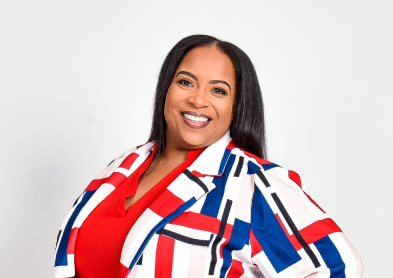 Sisters Café hostess, Gladys Bowden-Brown is in red and blue outfit.