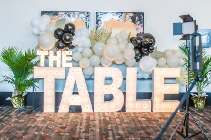 Lighted sign that reads The Table