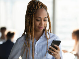 Young Black woman using social media to job search.