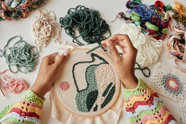 Black woman embroidering as one of the creative hobbies