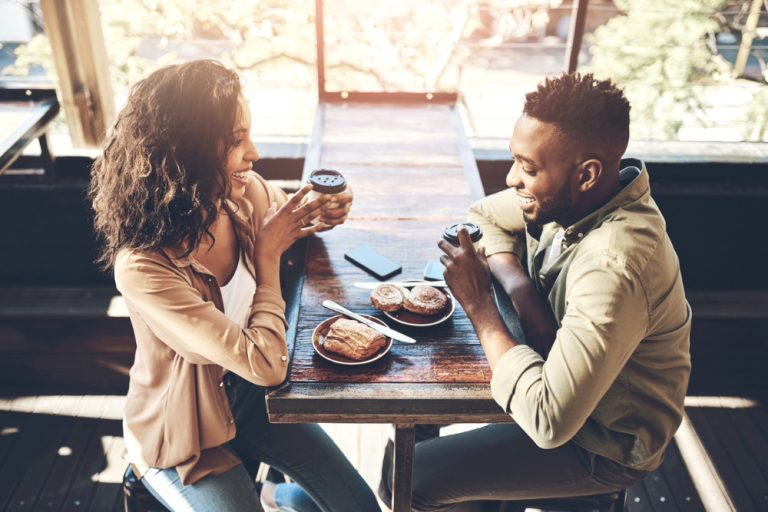 Black woman and man on coffee date according to their dating styles.