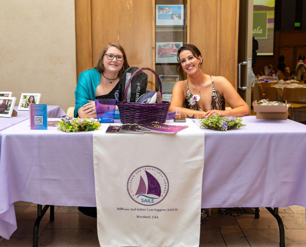 Volunteers from the SAILS organization at a table display.