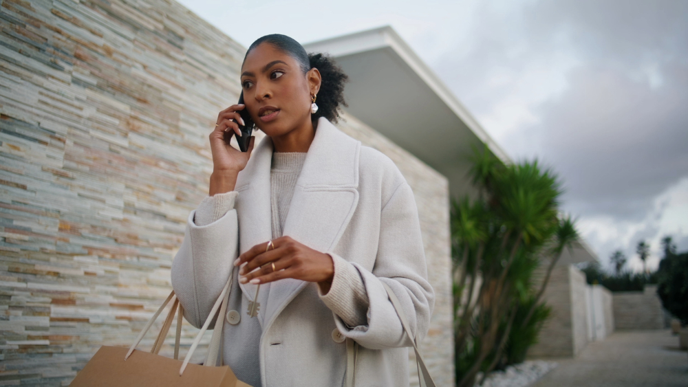 Black woman is the plug on the phone having a business conversation