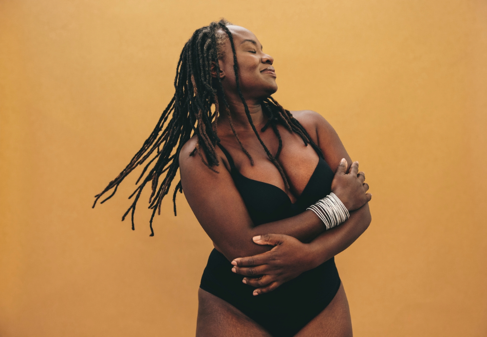 Aging Black woman loving on herself.