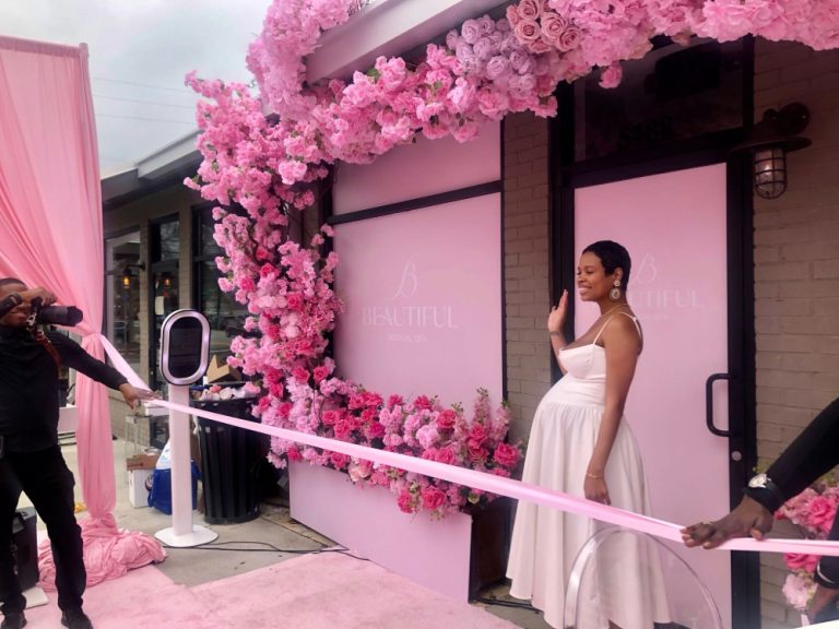 Briana Kelly in font of B Beautiful Medical Spa for ribbon cutting.