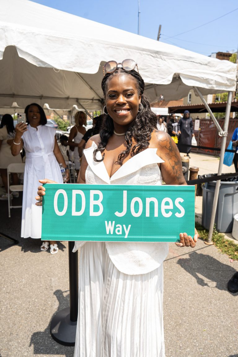 Taniqua Jones hold the ODB Jones Way sign.