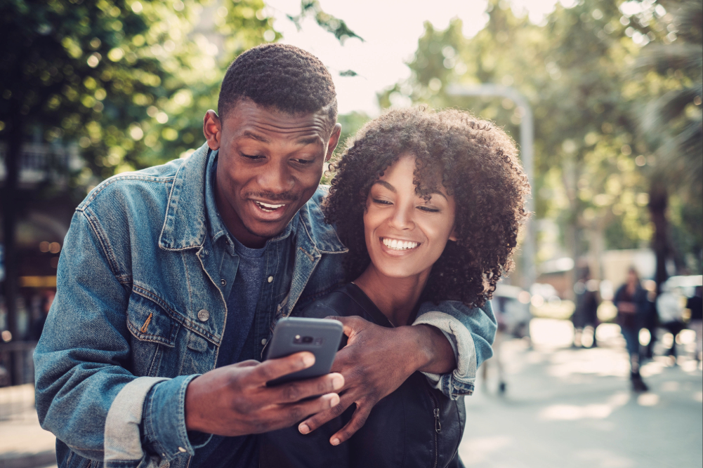 Your Soulmate Shouldn’t Feel Like a One-Hit Wonder: What Healthy Love Looks Like Black couple outdoors looking at phone