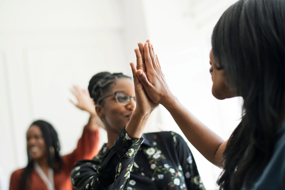 The Return to Ourselves: What Happens When Black Women Stop Competing and Start Building Together- Black women high-fiving