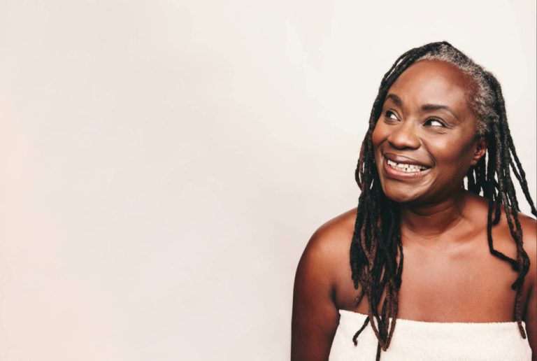 The Return to Ourselves: What Happens When Your Growth Changes Your Relationships - older Black woman smiling in towel