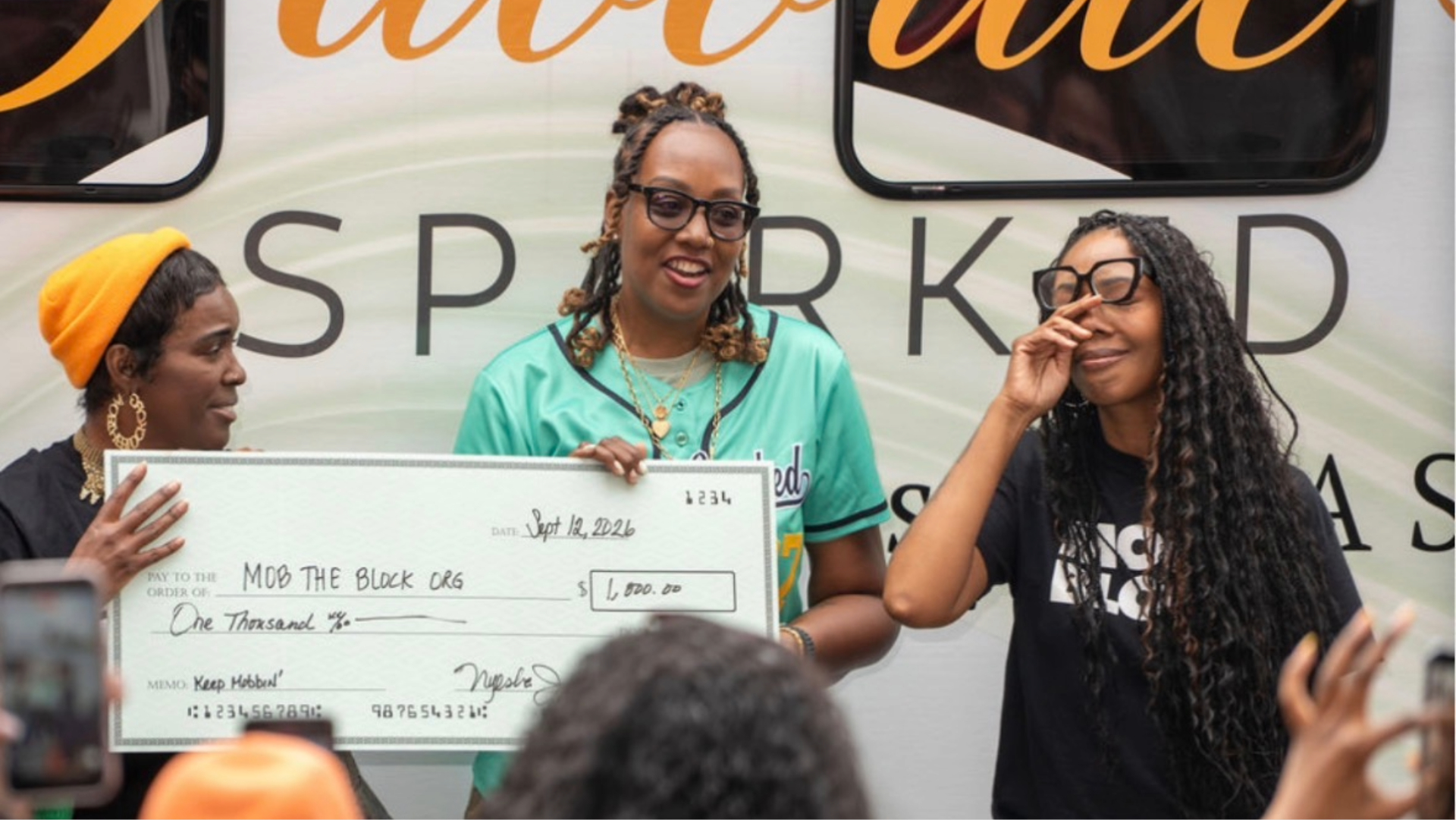 MOBFEST 2026 Brings Business, Community, and Connection to Howard UniversityNyesha Urbano of Favorite Spark presenting Mo the Block with a check.
