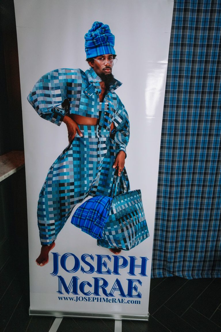 A Banner of Joseph McRae from his Project Runway premiere viewing event in NYC